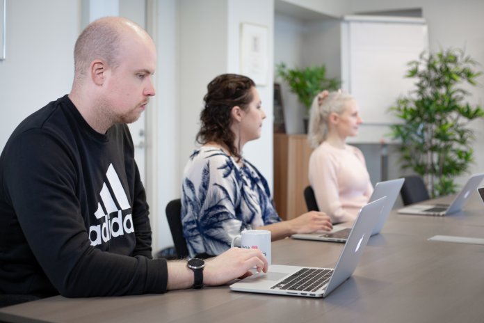 Liana employees at a meeting about B2B email marketing campaigns