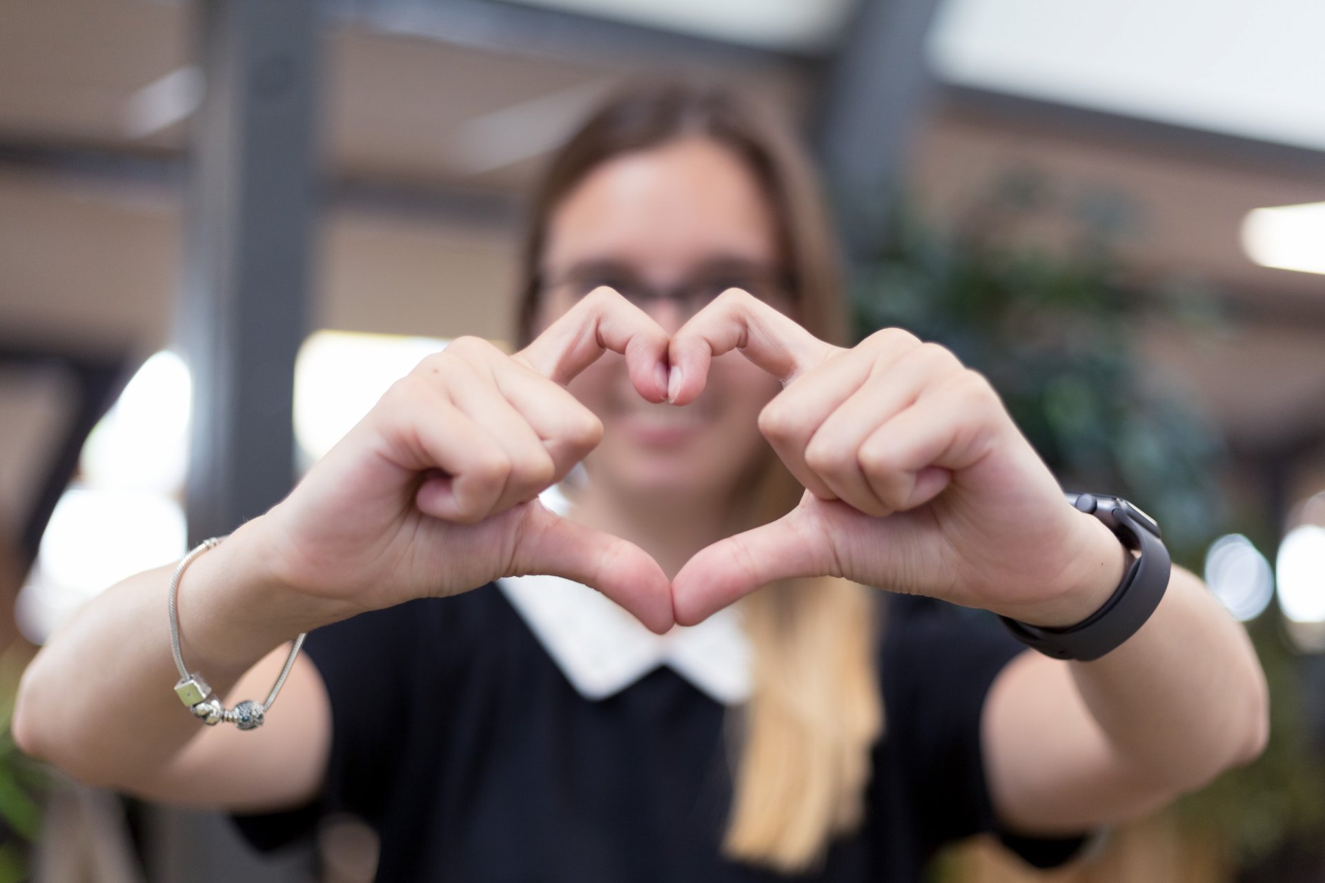 A person forming a heart with their fingers