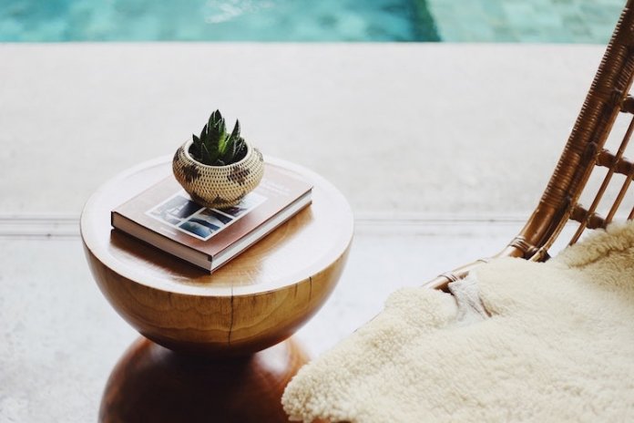 Small plant decoration and book on the table in hotel spa