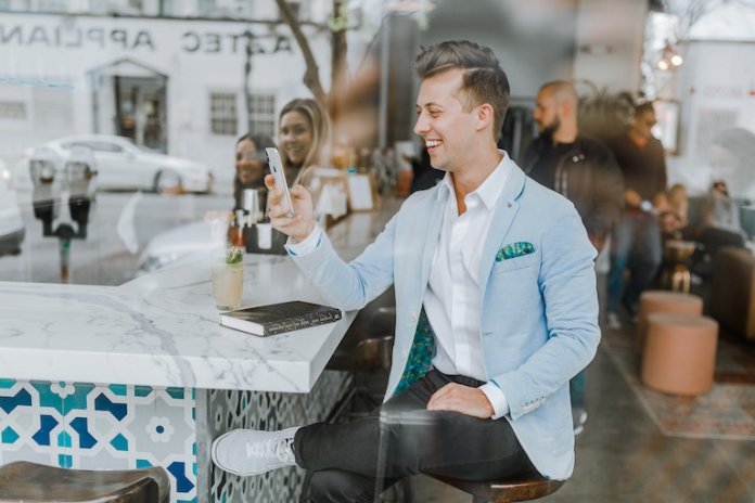 Man using a mobile device in a restaurant
